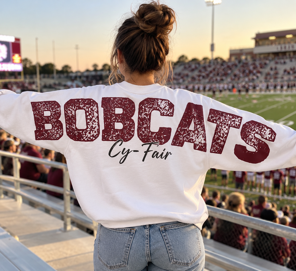 White crewneck BOBCATS Cy-Fair varsity design worn at stadium